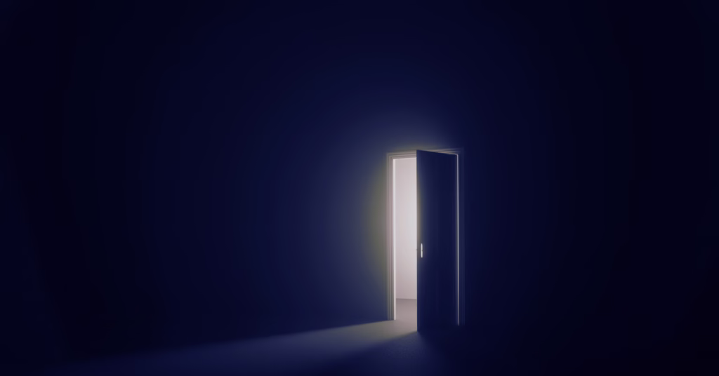 A single beam of light through a dark doorway, representing the shift from awareness of old patterns to the possibility of something different.